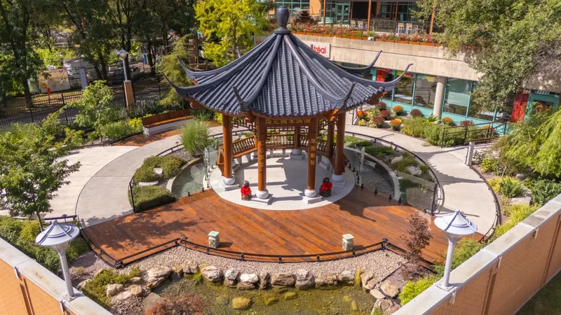 Aerial view of the octagonal Chinese temple pavilion, wood deck, and curved garden paths