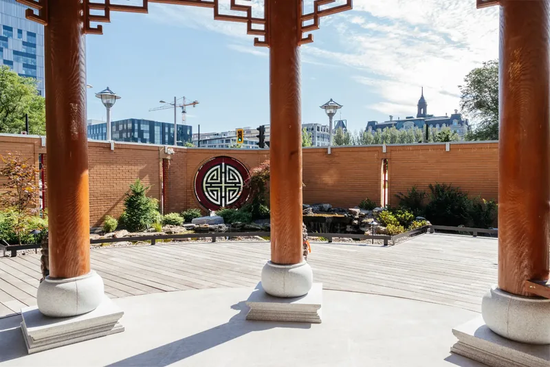 View from inside the temple pavilion toward the garden wall and its circular medallion
