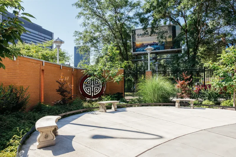 Curved garden plaza with stone bench and planting