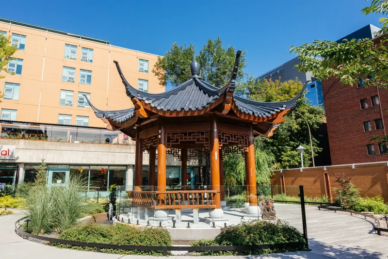 Traditional Chinese temple pavilion with upturned roof eaves in the hospital garden
