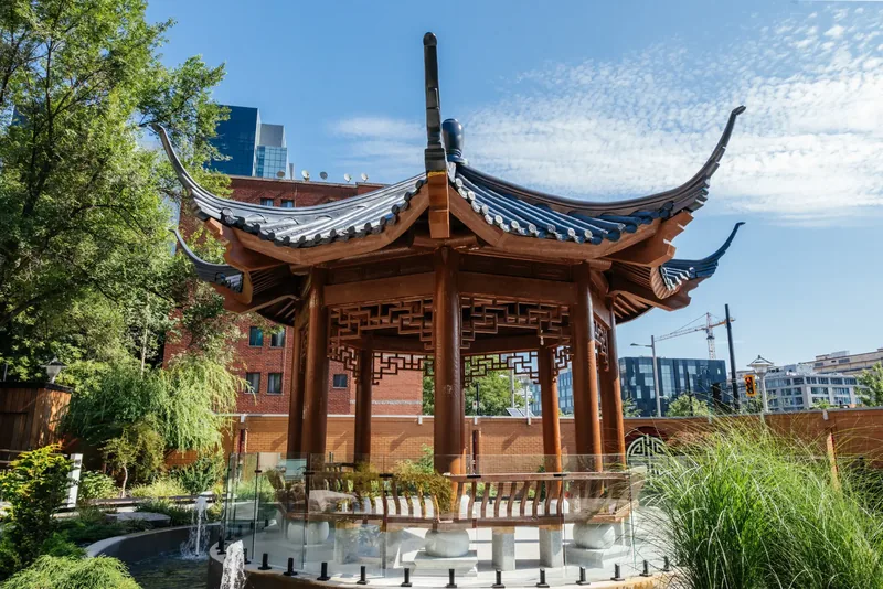 Traditional Chinese temple pavilion with upturned roof eaves in the hospital garden