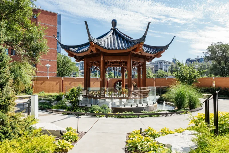 Traditional Chinese temple pavilion with upturned roof eaves in the hospital garden