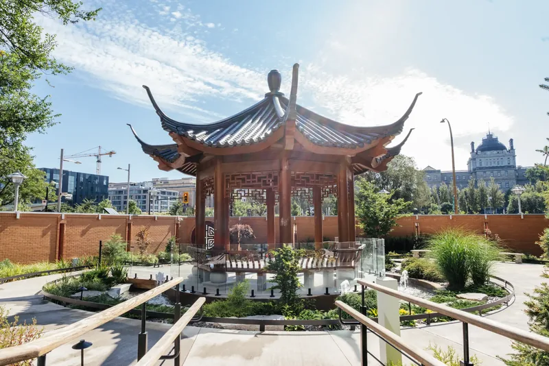 Traditional Chinese temple pavilion with upturned roof eaves in the hospital garden