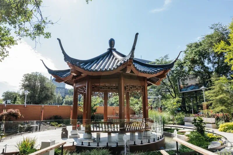 Traditional Chinese temple pavilion with upturned roof eaves in the hospital garden