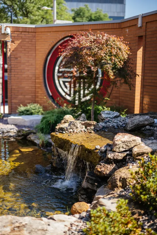 Rockwork waterfall flowing into the garden pond