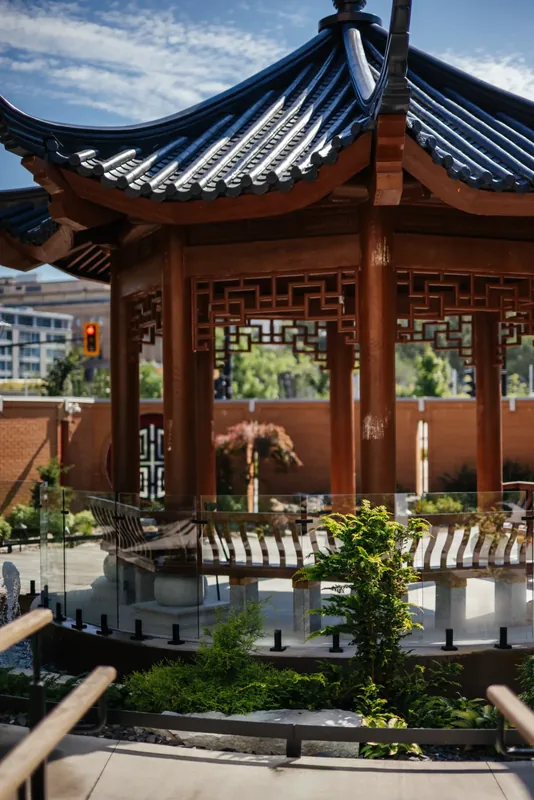 Traditional Chinese temple pavilion with upturned roof eaves in the hospital garden