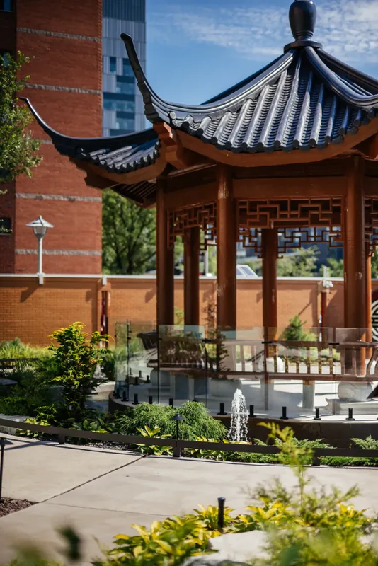 Traditional Chinese temple pavilion with upturned roof eaves in the hospital garden