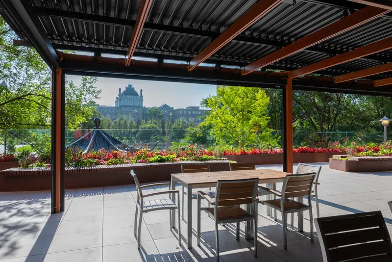 Dining tables beneath the terrace pergola