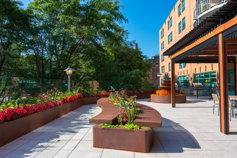 Steel planters with flowers lining the terrace