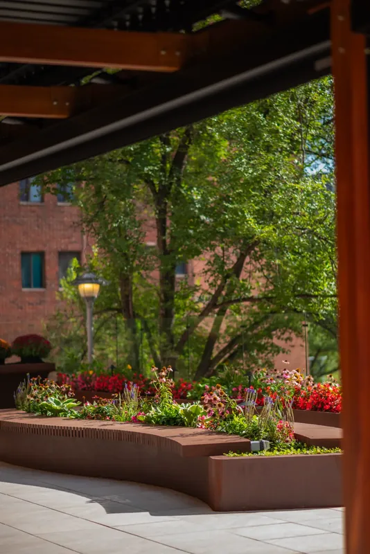 Steel planters with flowers lining the terrace