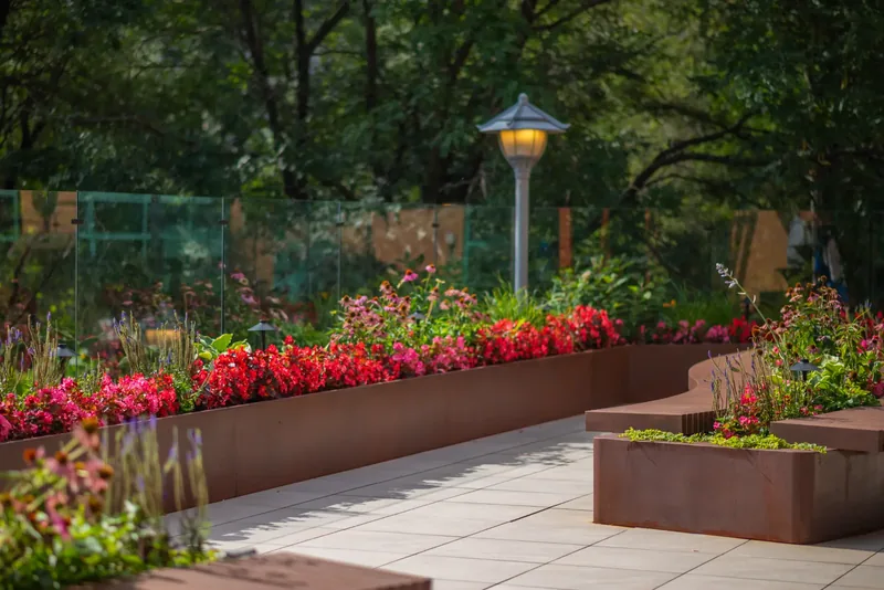 Steel planters with flowers lining the terrace