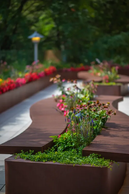 Wood bench integrated into a terrace planter