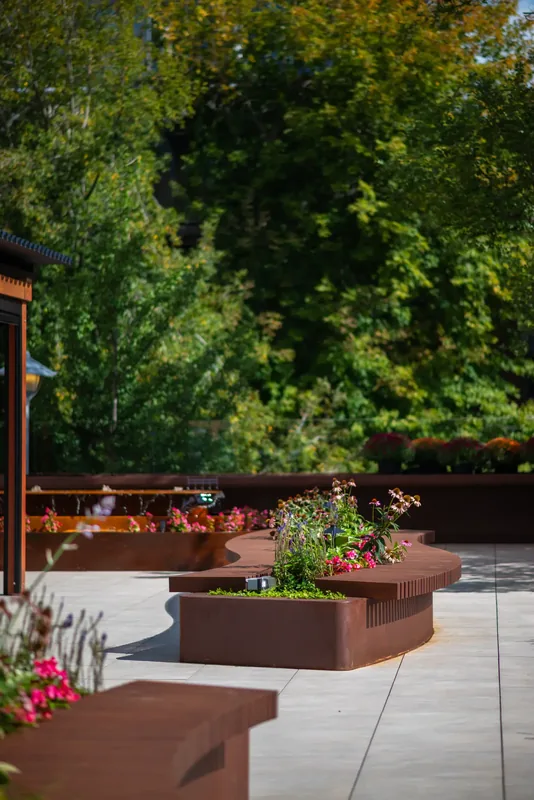 Wood bench integrated into a terrace planter