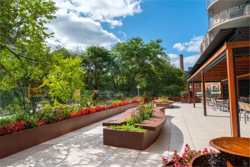 Steel planters with flowers lining the terrace
