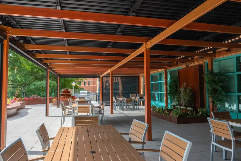 Dining tables beneath the terrace pergola