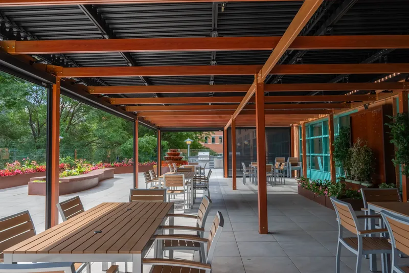 Dining tables beneath the terrace pergola