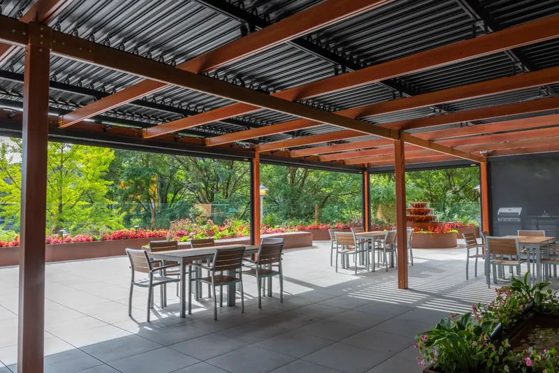 Dining tables beneath the terrace pergola