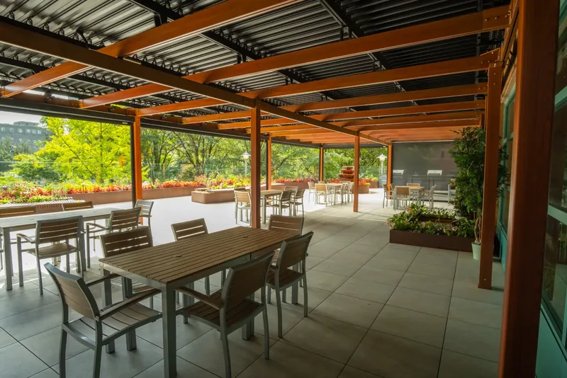 Dining tables beneath the terrace pergola