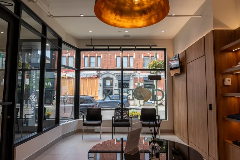 Full-height front windows framing the street, with a copper-lined dome pendant and wood panelling