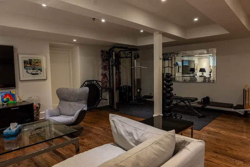 Lower-level lounge with an adjoining home gym