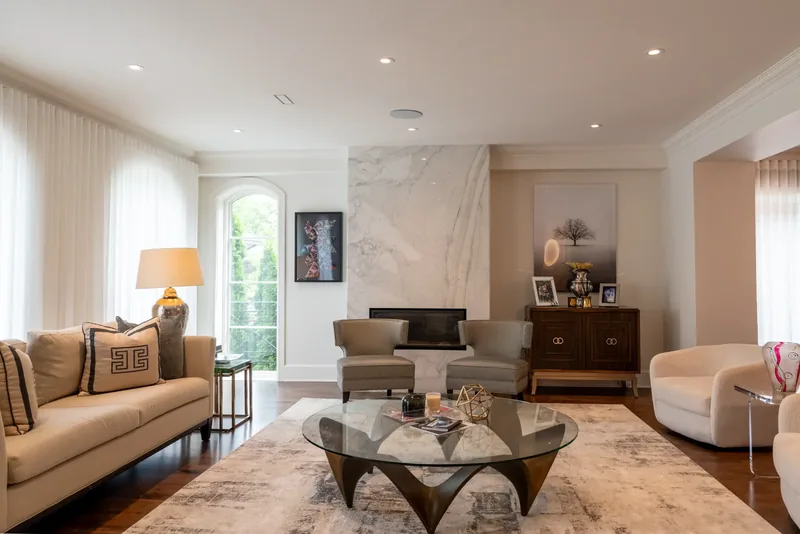 Living room with a marble fireplace wall and a sculptural coffee table
