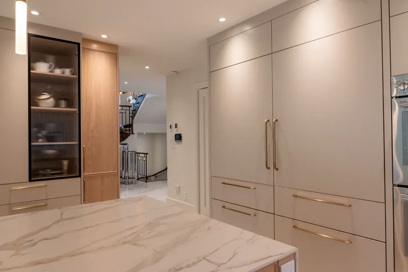 Floor-to-ceiling cabinetry with glass-front display units