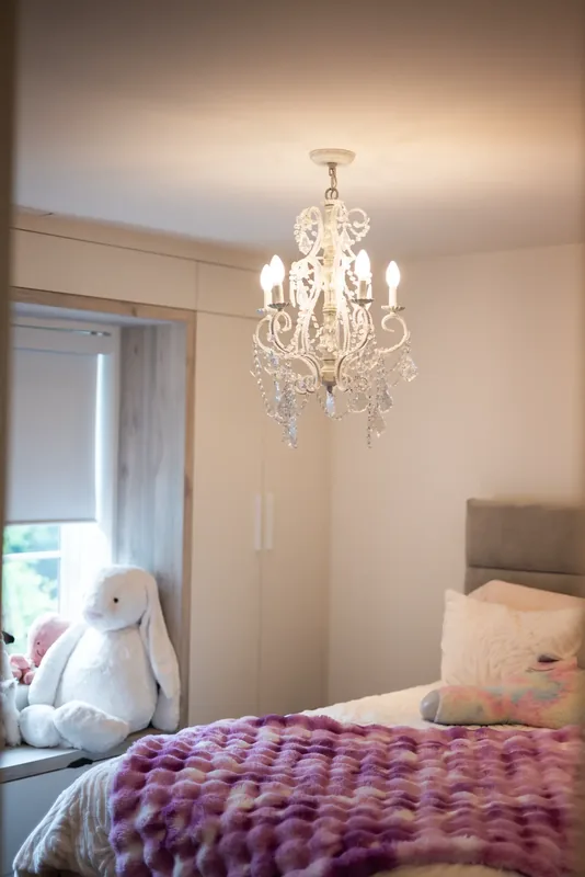 Child’s bedroom with a crystal chandelier