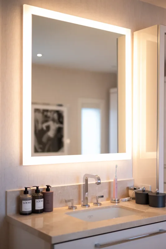Bathroom vanity with a backlit mirror