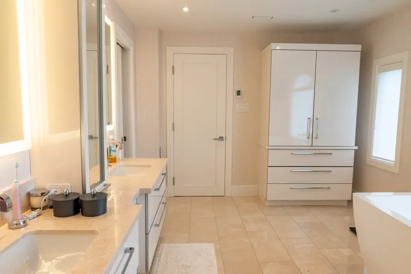 Primary ensuite with a double floating vanity and backlit mirrors