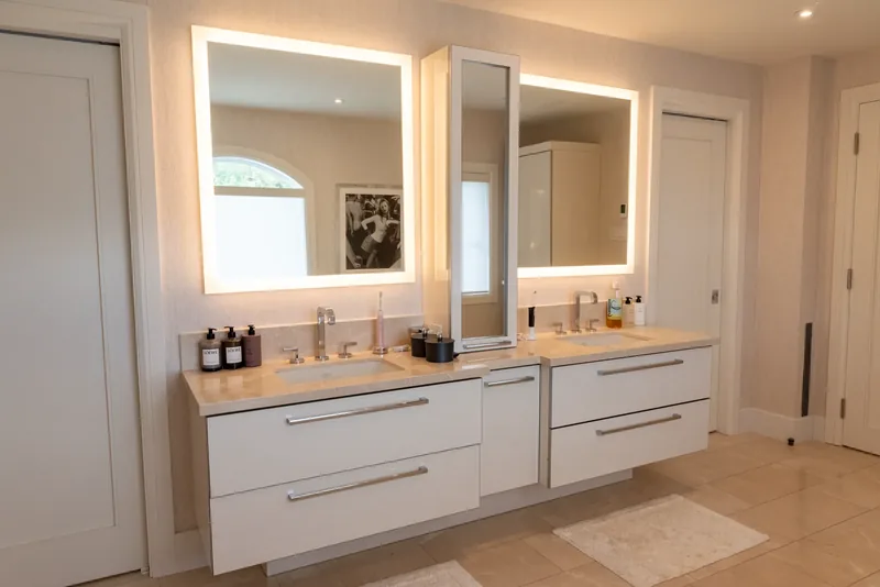 Primary ensuite with a double floating vanity and backlit mirrors