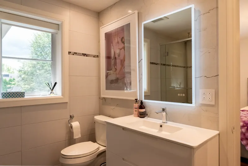 Bathroom vanity with a backlit mirror