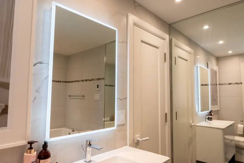 Bathroom vanity with a backlit mirror