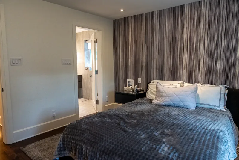 Bedroom with custom shelving and soft natural light