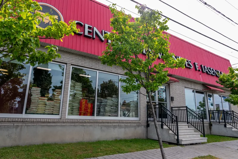 Iasenza store with grey brick walls, red metal upper cladding, large windows, and concrete stairs with black railings