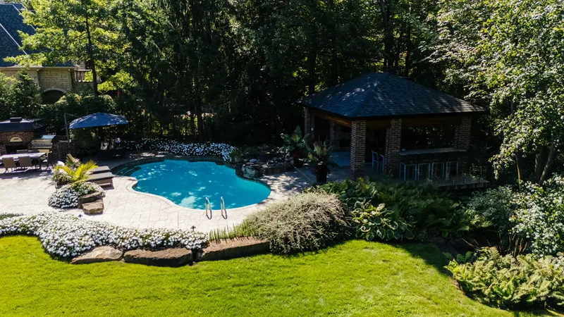 Aerial view of the rear terrace, the cedar pavilion, and borders of white flowers
