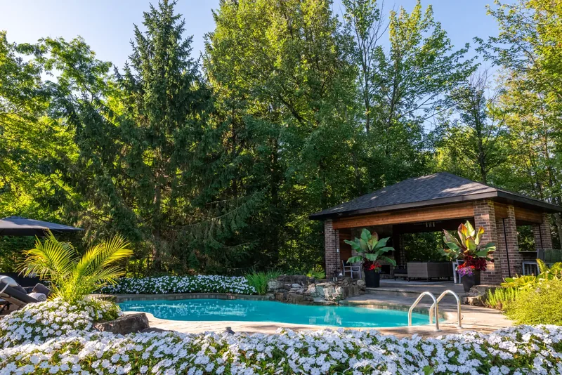 Stone terrace with natural rock edging and drifts of white flowers