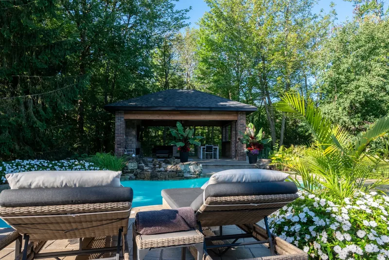 Lounge chairs and umbrellas on the stone terrace by the water