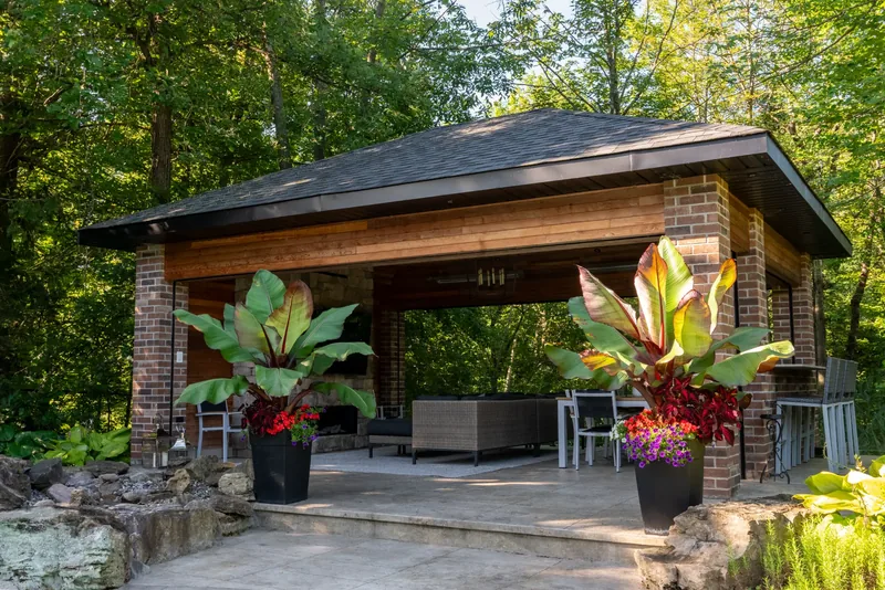 Cedar and brick pavilion with tropical planters