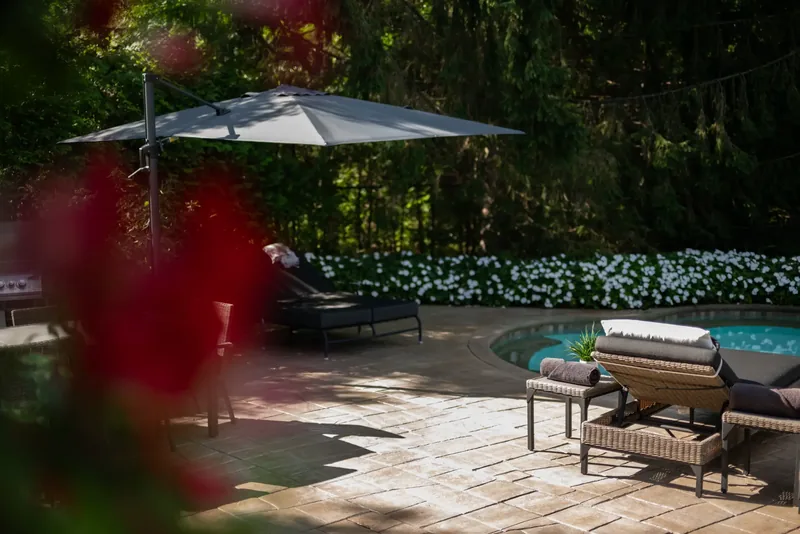 Lounge chairs and umbrellas on the stone terrace by the water