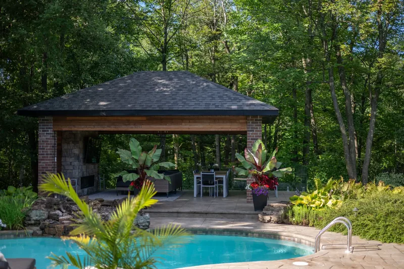 Cedar pavilion at the water’s edge with tropical planters