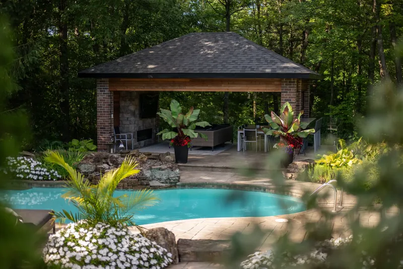 Cedar pavilion at the water’s edge with tropical planters