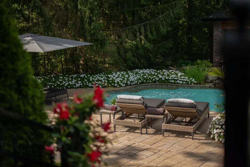 Lounge chairs and umbrellas on the stone terrace by the water
