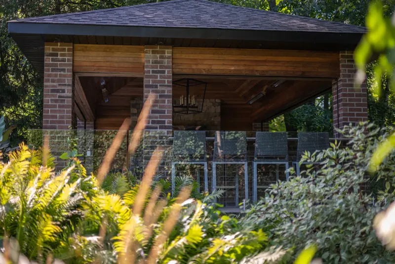 Cedar and brick pavilion with tropical planters