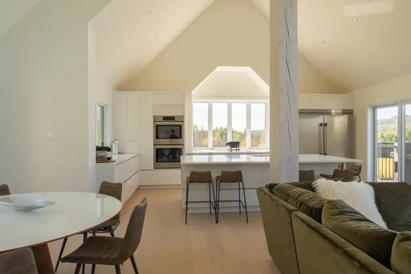 Open plan connecting the dining area, the kitchen island, and the great room
