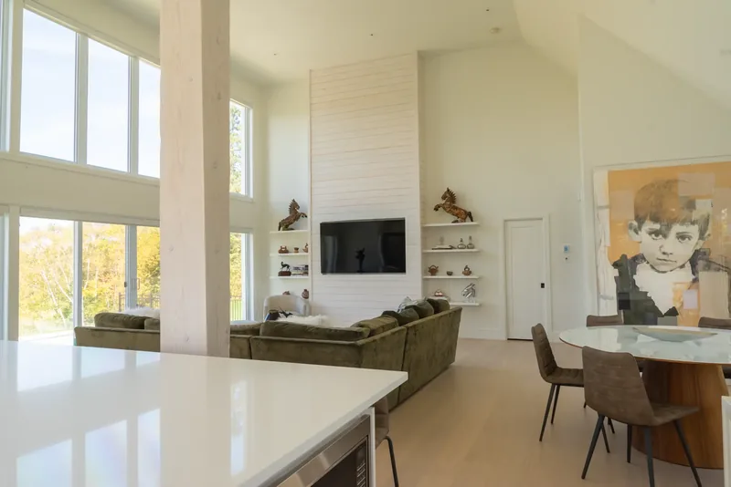 White shiplap media wall with floating shelves and decorative objects