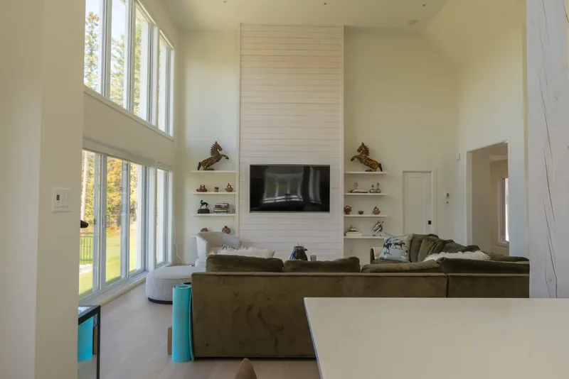 White shiplap media wall with floating shelves and decorative objects