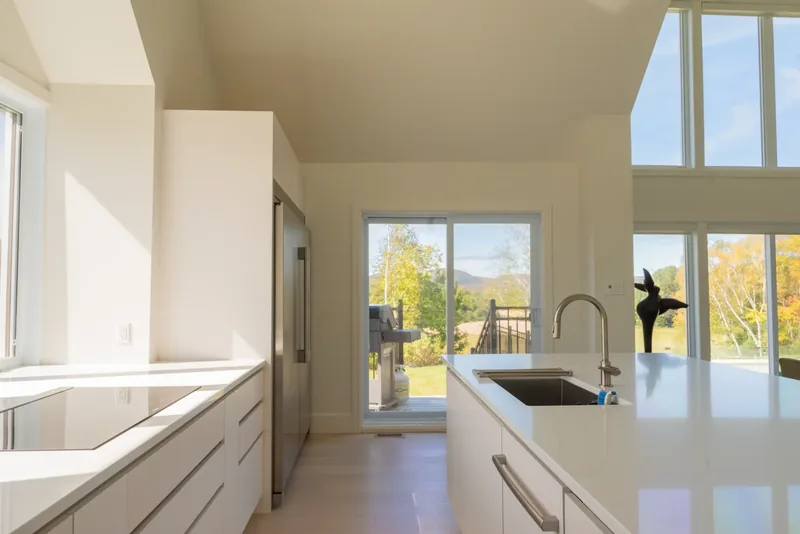 Kitchen island and cooktop beside the patio doors