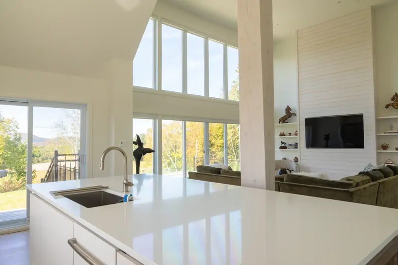 Kitchen island opening onto the great room and its windows