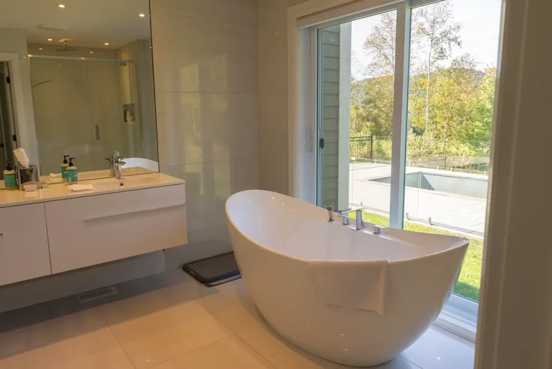 Ensuite with a floating double vanity and a freestanding tub