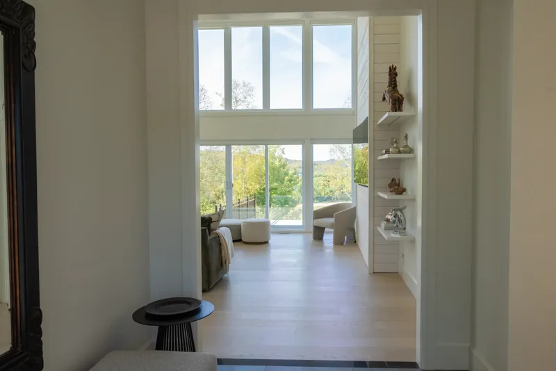 Hallway view into the great room and its double-height windows